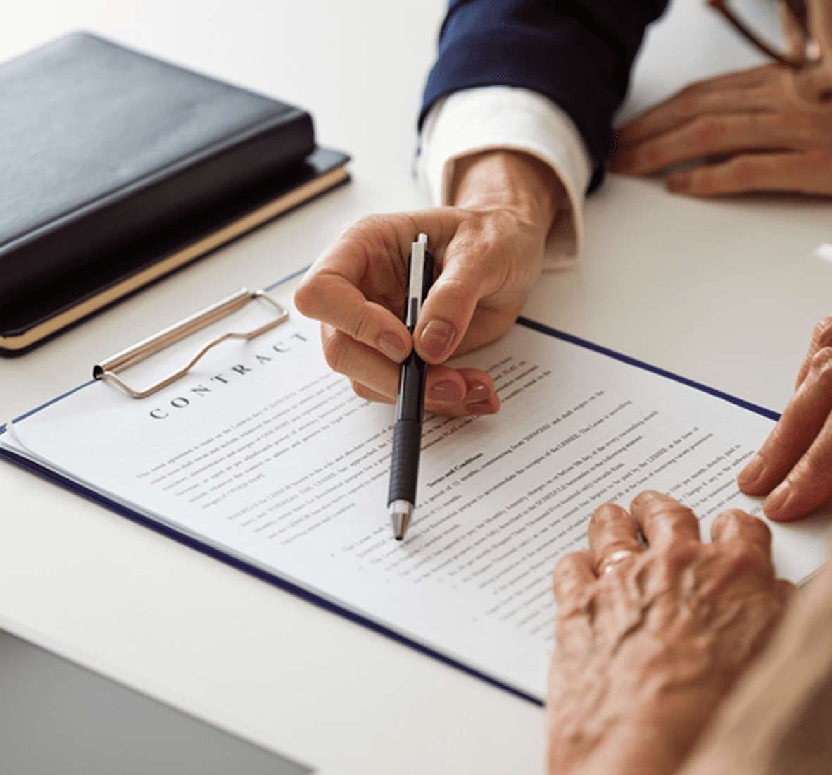 Two people reviewing a contract document