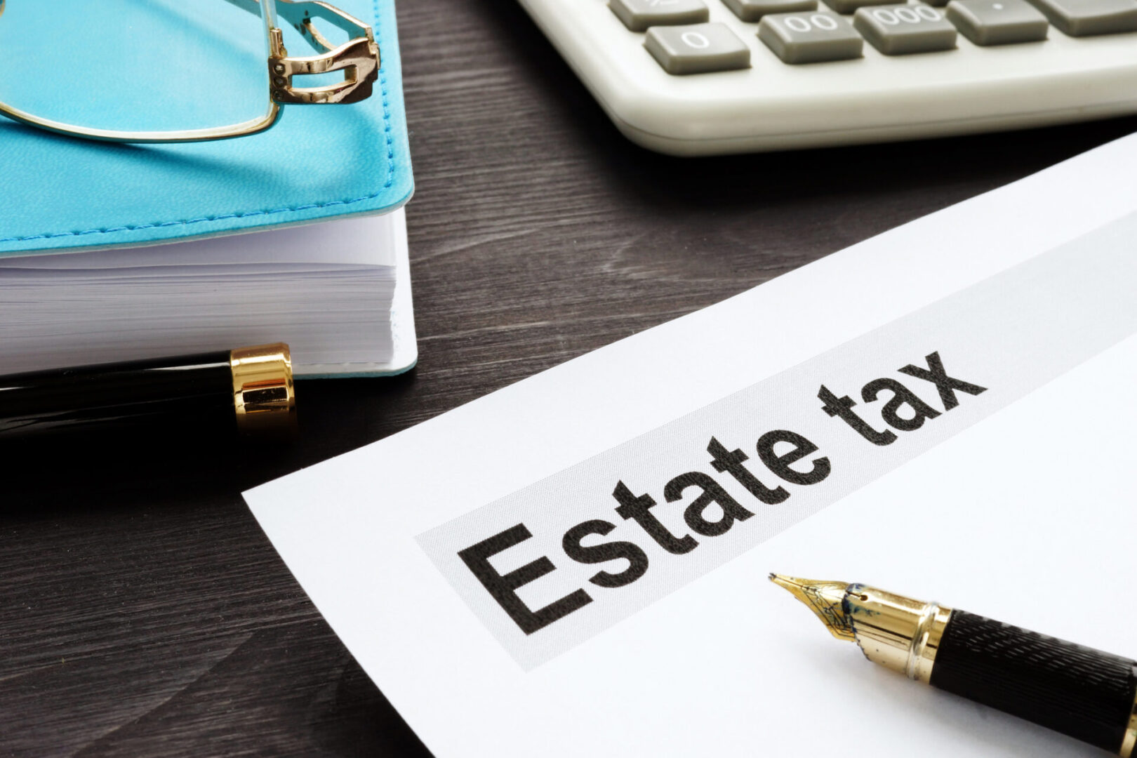 Estate tax and gavel on a wooden desk.