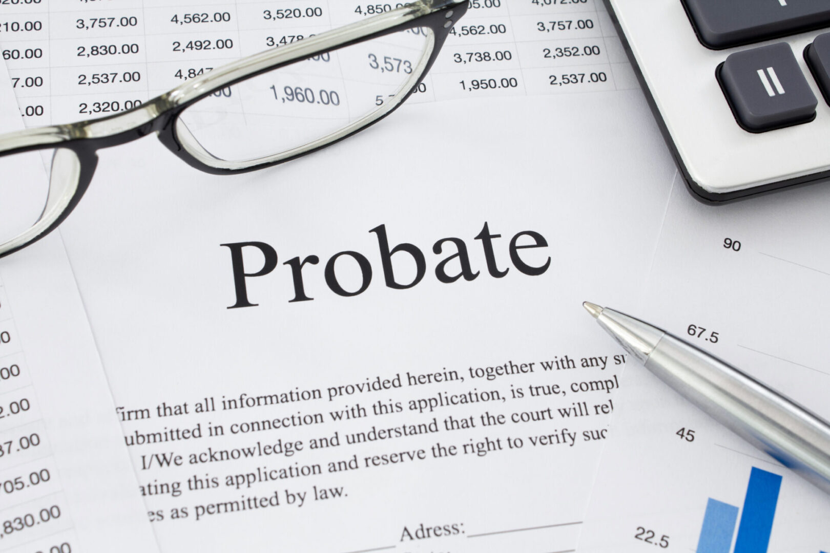 Probate Document on a desk with glasses, a pen, calculator and financial documents. 
Shot from above. Close up.